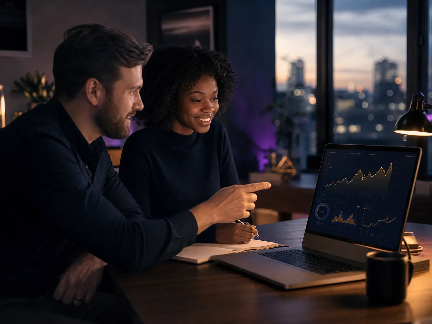 A Celestial coach reviews performance charts with a creator on a laptop